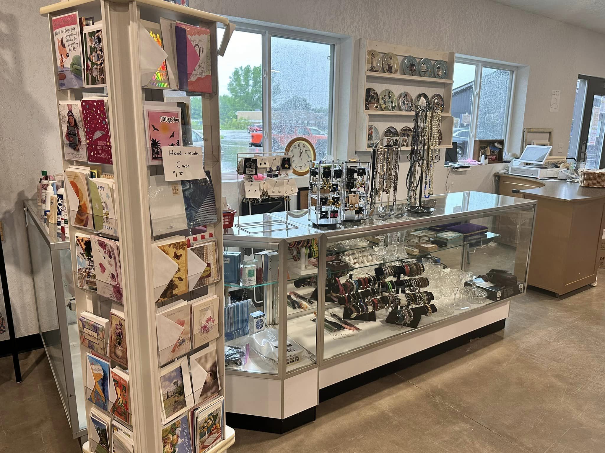 Cards, jewelry, and home goods inside The Bridge Thrift Store